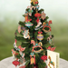 Decorative Christmas tree with colorful ornaments on a white surface.